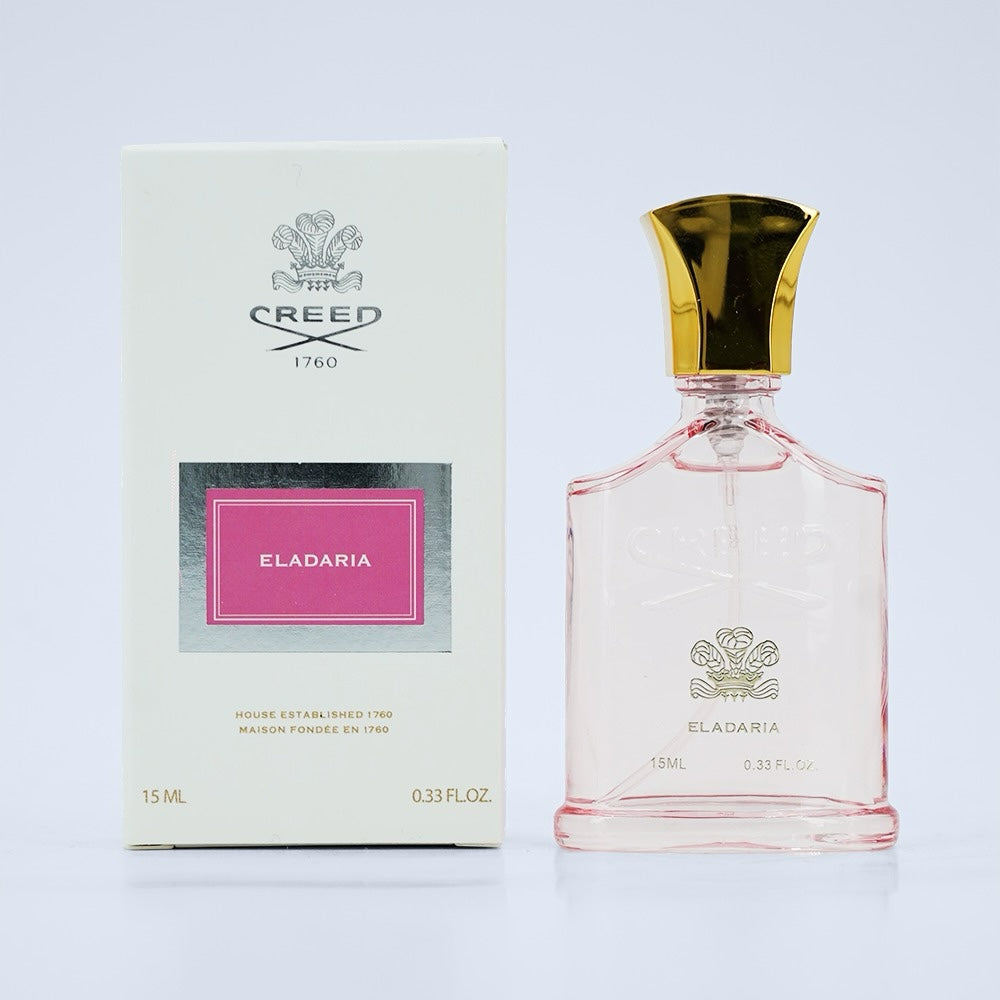 Nevora Creed Eladaria 15ml eau de parfum in a glass bottle with a gold cap next to its white and pink branded box.