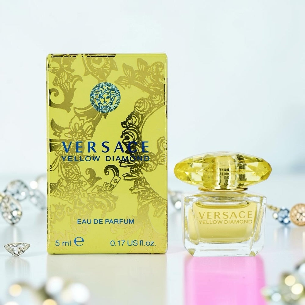 Nevora Versace Yellow Diamond miniature perfume bottle and box with jewel-like cap on a white surface